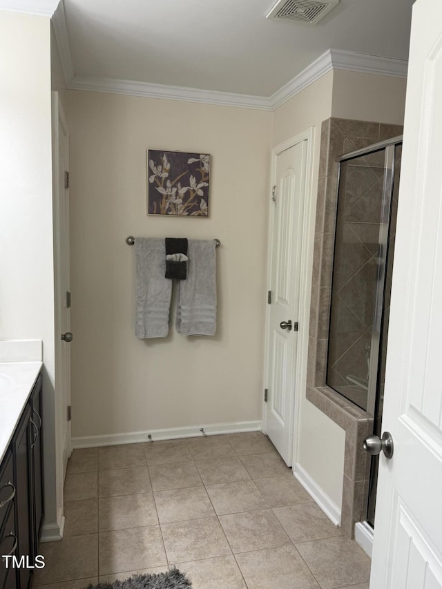 hallway with visible vents, ornamental molding, baseboards, and light tile patterned flooring