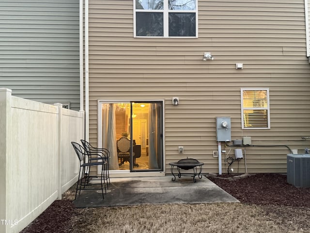 rear view of property featuring central AC, a patio, and fence