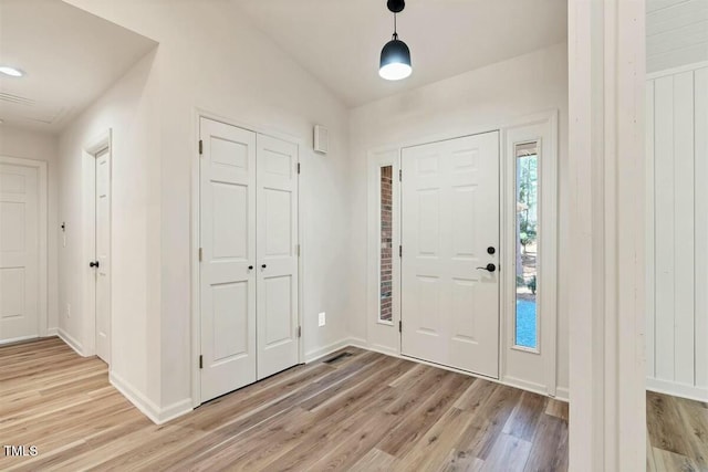 foyer entrance with light wood-type flooring and baseboards