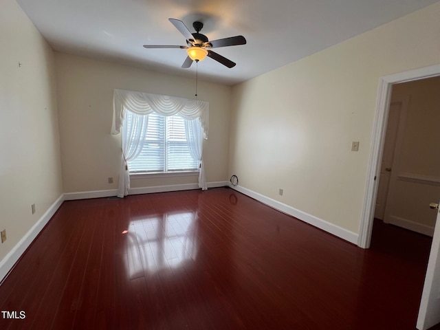 unfurnished room featuring ceiling fan, wood finished floors, and baseboards