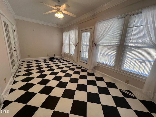 unfurnished room with ornamental molding, tile patterned floors, baseboards, and a ceiling fan