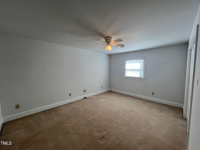 unfurnished bedroom featuring light carpet, baseboards, and a ceiling fan