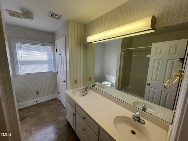 full bathroom featuring a sink, visible vents, and wallpapered walls