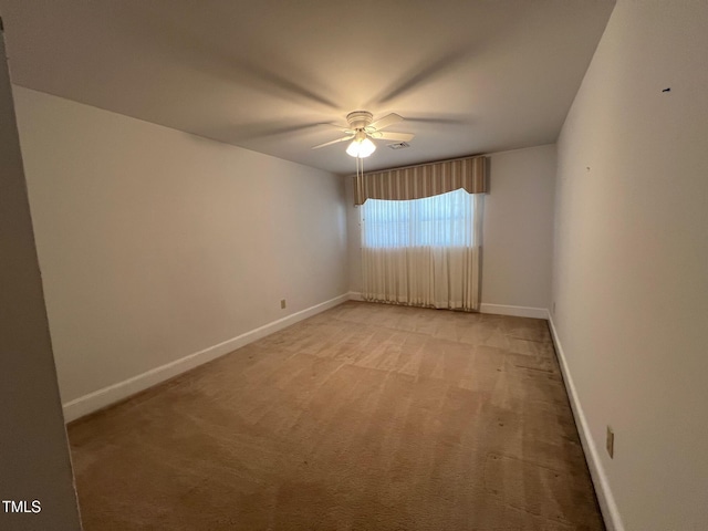 empty room with light carpet, baseboards, and a ceiling fan