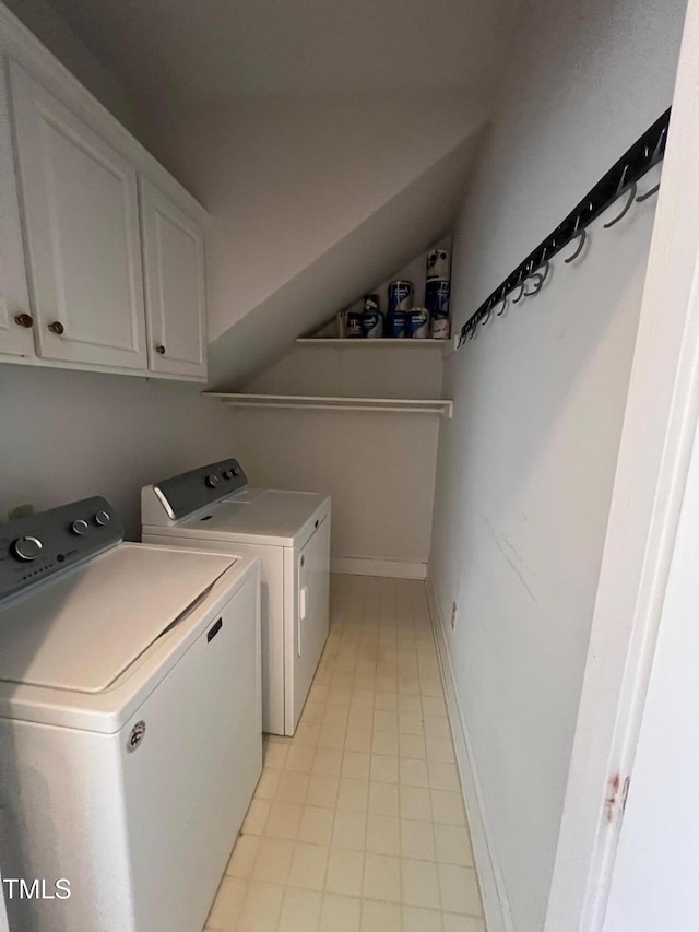 laundry area featuring independent washer and dryer, cabinet space, and baseboards