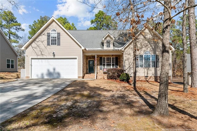 view of front facade with a garage, driveway, and a porch