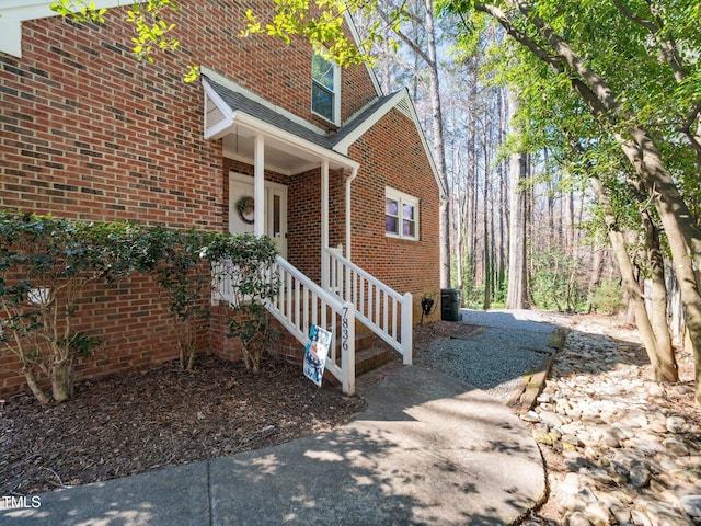 view of side of home with brick siding