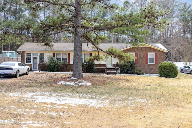 ranch-style home with brick siding, crawl space, and a front lawn