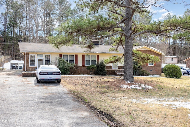 ranch-style house with crawl space, aphalt driveway, and brick siding