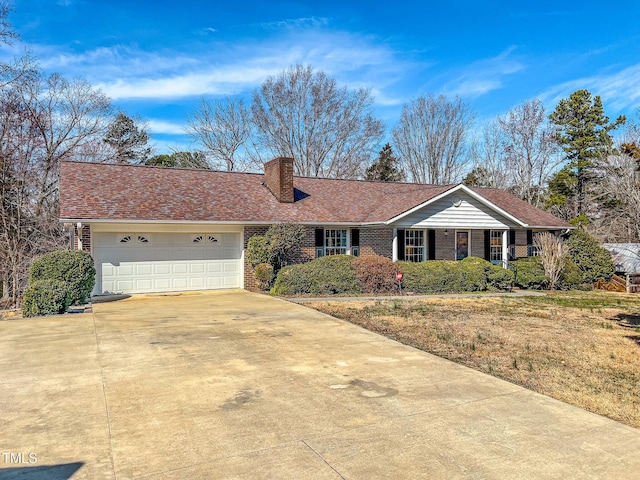 ranch-style house with a garage, a chimney, concrete driveway, and brick siding