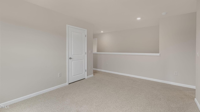 unfurnished room featuring recessed lighting, baseboards, and light colored carpet