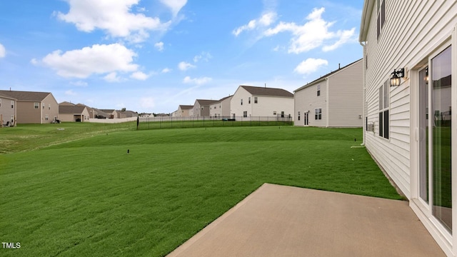 view of yard with a residential view, fence, and a patio