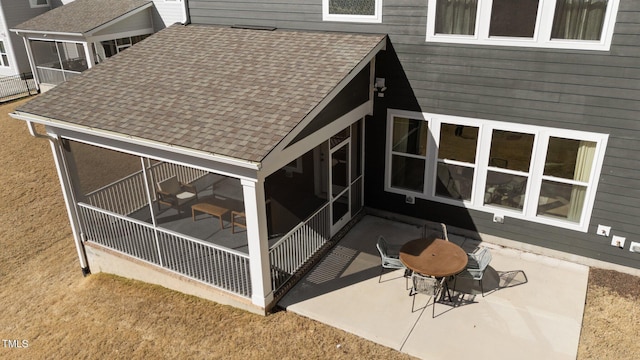 exterior space featuring a patio and a shingled roof