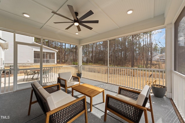 sunroom featuring ceiling fan