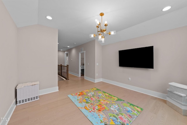 rec room featuring light wood finished floors, baseboards, a chandelier, and recessed lighting