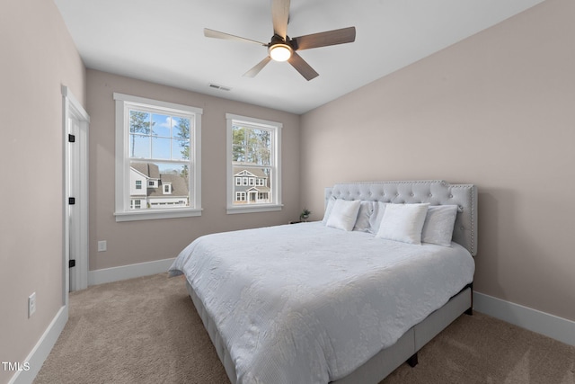 bedroom featuring light carpet, baseboards, visible vents, and a ceiling fan