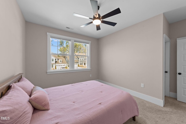 bedroom featuring light carpet, ceiling fan, visible vents, and baseboards