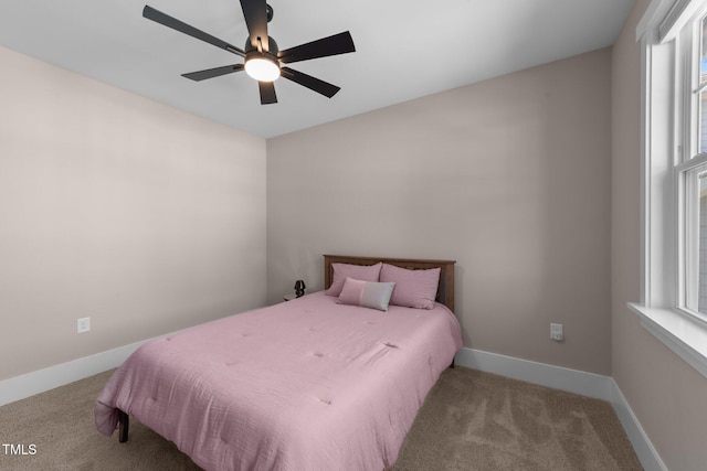 bedroom featuring baseboards, a ceiling fan, and light colored carpet