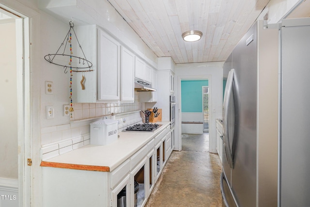 kitchen with light countertops, decorative backsplash, appliances with stainless steel finishes, white cabinets, and under cabinet range hood