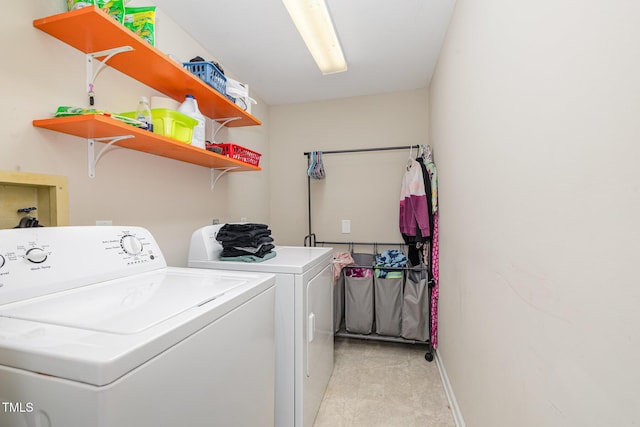 washroom with laundry area, baseboards, and separate washer and dryer