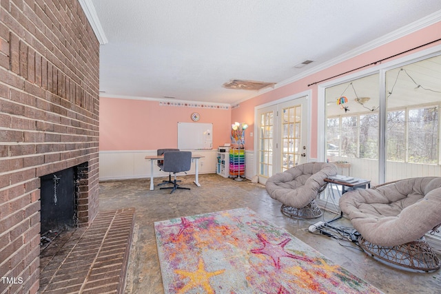 office space featuring concrete floors, visible vents, french doors, a brick fireplace, and crown molding