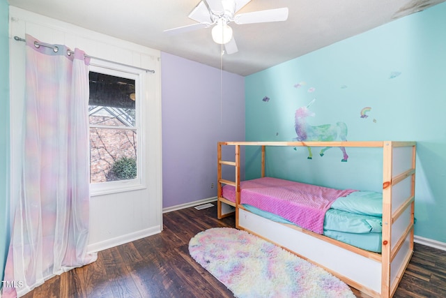 bedroom featuring ceiling fan, dark wood-type flooring, and baseboards