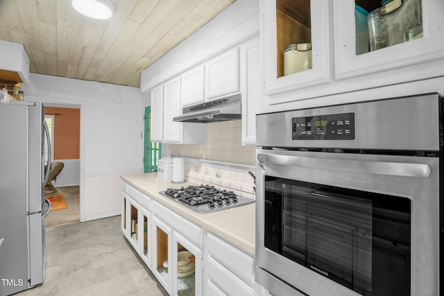214 Woodcrest Ave, Smithfield, NC 27577 - kitchen with stainless steel appliances, white cabinetry, wood ceiling, light countertops, and under cabinet range hood