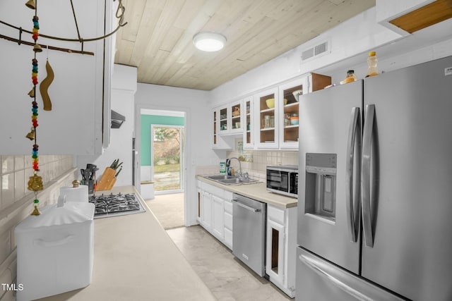 214 Woodcrest Ave, Smithfield, NC 27577 - kitchen featuring stainless steel appliances, a sink, wood ceiling, light countertops, and tasteful backsplash