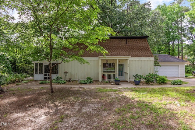 214 Woodcrest Ave, Smithfield, NC 27577 - view of front of property with a sunroom, a garage, a shingled roof, and asphalt driveway