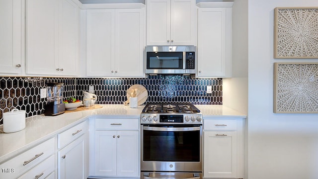 kitchen with stainless steel appliances, white cabinets, light countertops, and decorative backsplash