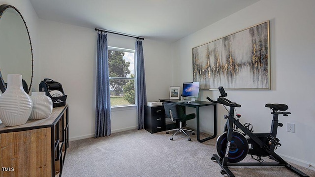 office area with light carpet and baseboards