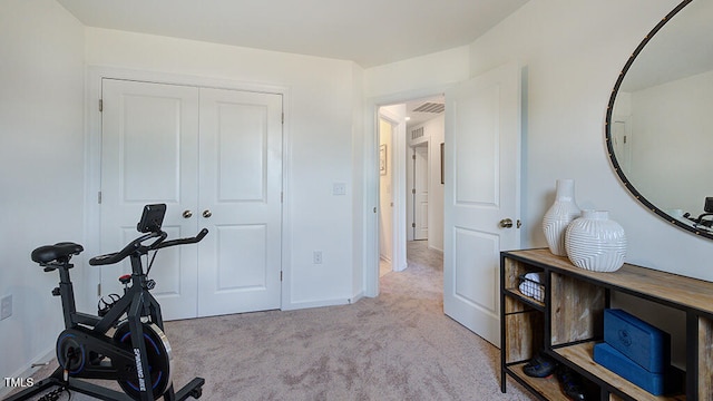 workout area with light carpet, visible vents, and baseboards