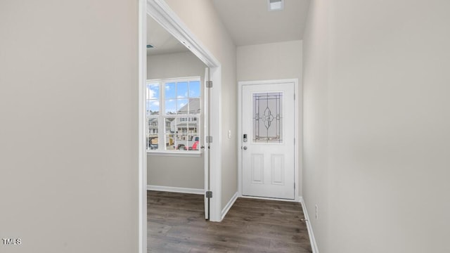 entryway with dark wood-style flooring, visible vents, and baseboards