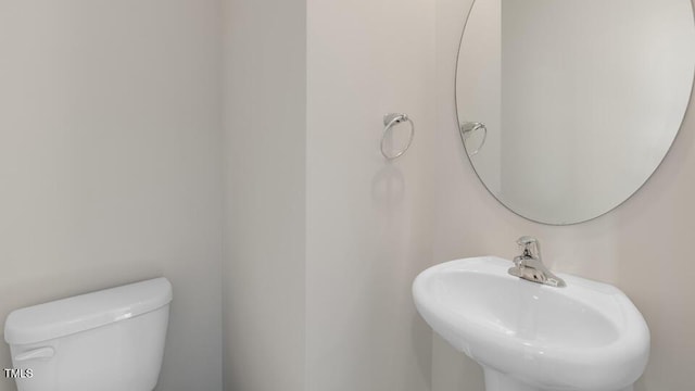 bathroom featuring toilet and a sink