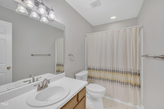 bathroom featuring toilet, vanity, visible vents, a shower with curtain, and tile patterned floors