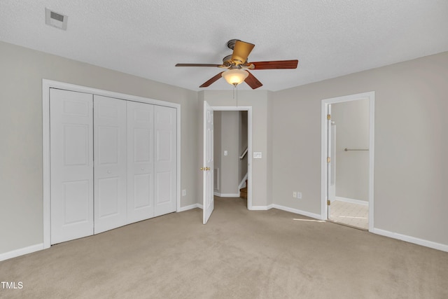 unfurnished bedroom featuring a closet, carpet, visible vents, and baseboards