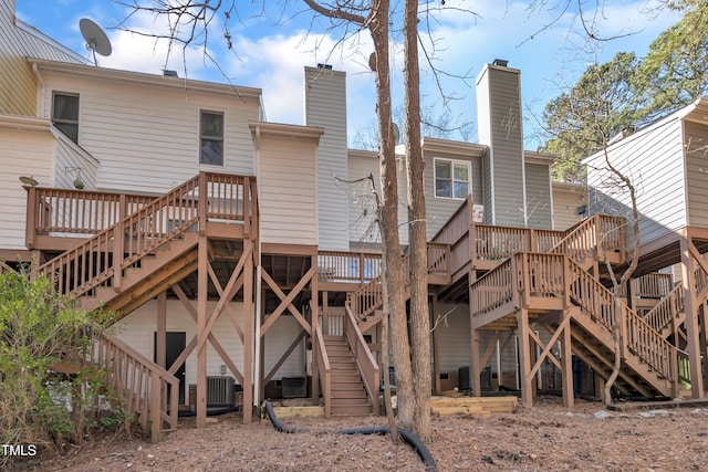 back of house featuring a deck, stairway, and central AC unit