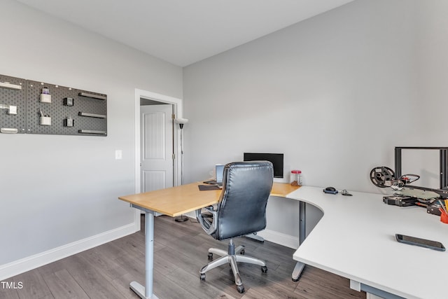 office featuring baseboards and wood finished floors