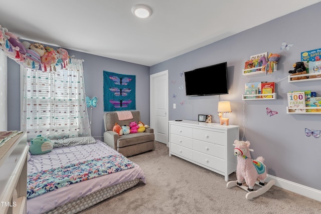 carpeted bedroom featuring baseboards