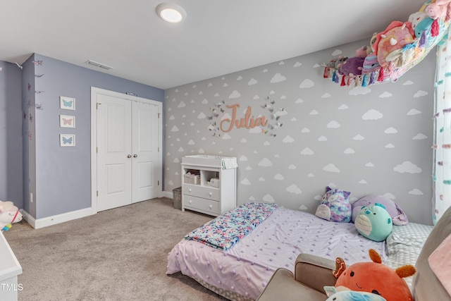 bedroom with carpet floors, visible vents, baseboards, a closet, and wallpapered walls