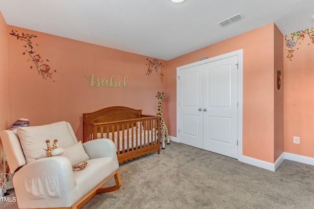 bedroom featuring a closet, visible vents, carpet flooring, a nursery area, and baseboards