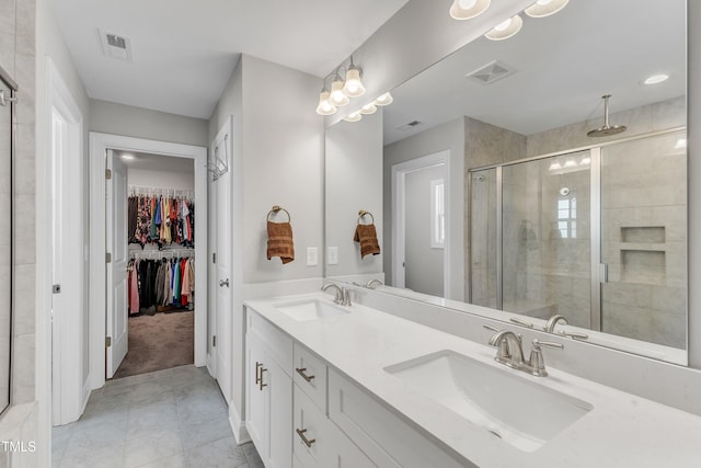 full bath with a shower stall, visible vents, and a sink