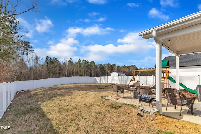 view of yard featuring a fenced backyard and a playground