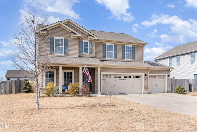 view of front of house with a shingled roof, concrete driveway, fence, and a garage