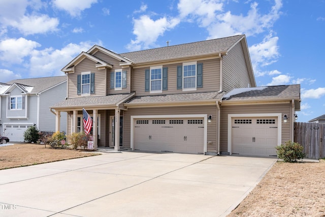 view of front of property with concrete driveway, a shingled roof, and fence