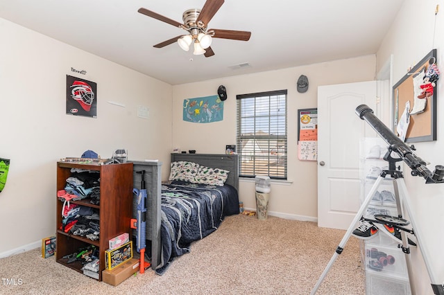 carpeted bedroom with a ceiling fan, visible vents, and baseboards