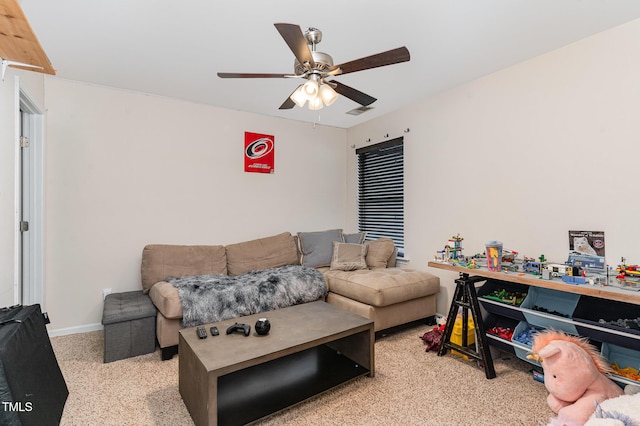 living area featuring baseboards, visible vents, and a ceiling fan