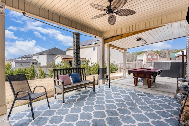 view of patio / terrace with a ceiling fan, a residential view, and fence