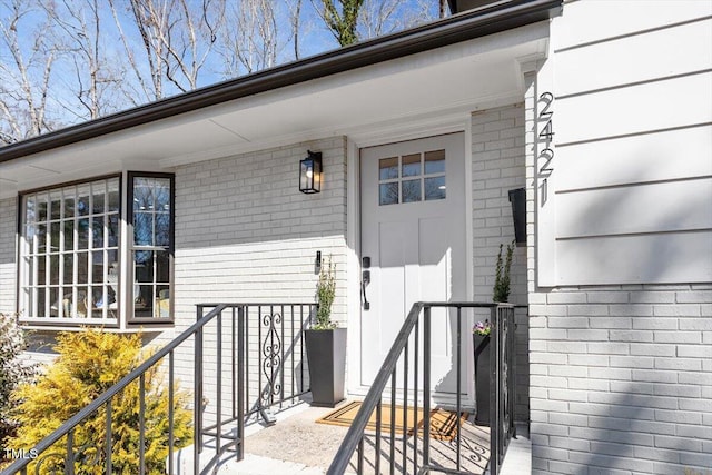 view of exterior entry with brick siding