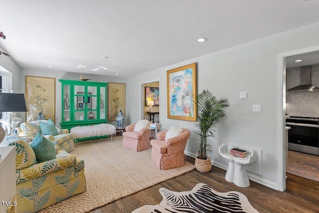 living room featuring baseboards, wood finished floors, and recessed lighting